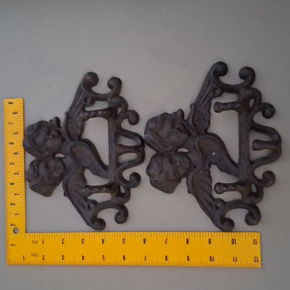 They're vintage cast iron cherub hooks